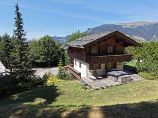 Experience the ultimate mountain retreat in this charming wooden chalet, boasting stunning panoramic views of the surrounding Alps.