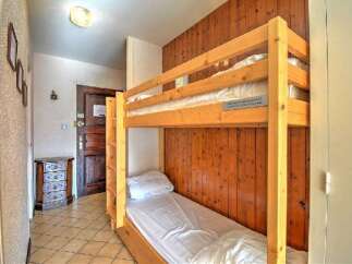 This cozy room features a space-saving bunk bed, perfect for maximizing sleeping arrangements.