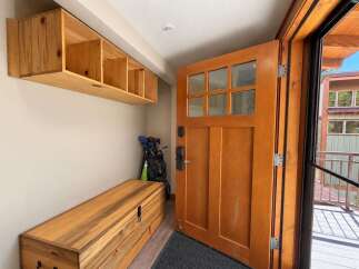 Welcome home to this charming entryway, featuring a beautiful wooden door with glass panes that invite natural light.