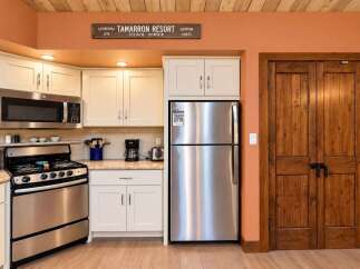Step into this charming kitchen featuring stainless steel appliances, including a microwave, oven, and refrigerator, perfect for any home chef.