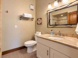 This charming bathroom features a spacious vanity with a granite countertop and a modern sink, perfect for your morning routine.
