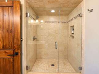Step into this beautifully appointed bathroom featuring a spacious glass-enclosed shower with elegant tile work.