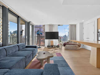 Experience luxury urban living in this stunning apartment, featuring a spacious open-concept living area with floor-to-ceiling windows offering breathtaking city views.