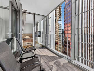 Experience breathtaking city views from this modern balcony, perfect for enjoying your morning coffee or evening drinks.