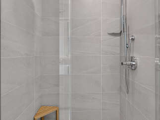 Step into a modern oasis with this stunning walk-in shower, featuring sleek, large-format gray tiles that create a spa-like ambiance.
