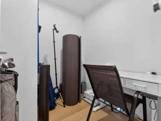 This home office space features a sleek white desk with drawers, perfect for organization and productivity.