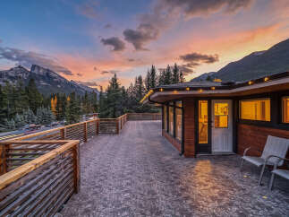 Experience breathtaking mountain views from this expansive deck, perfect for enjoying stunning sunsets.