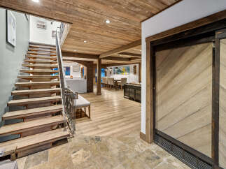 Discover this stunning home featuring a beautiful wooden staircase leading to an open-concept living area.