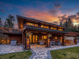 Experience luxurious outdoor living with this stunning modern home, featuring a spacious covered patio perfect for entertaining.