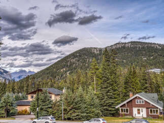 Nestled amidst a lush forest, this charming property offers a serene mountain retreat.