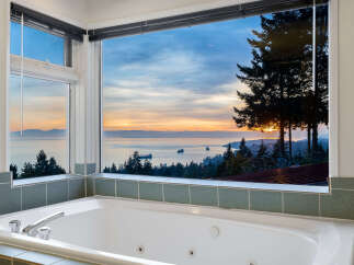 Indulge in breathtaking ocean views from this luxurious jetted bathtub, perfect for unwinding after a long day.