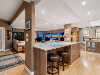 This open-concept living space features a modern kitchen island with seating, perfect for casual dining and entertaining.