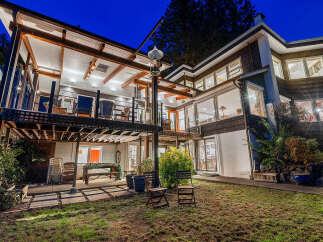 Experience luxurious living in this multi-level home, featuring expansive decks and large windows that invite natural light.