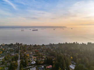 Experience breathtaking panoramic views of the ocean and distant mountains from this stunning property.