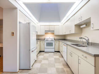 This U-shaped kitchen boasts ample cabinet space and a bright, airy feel thanks to the large skylight.