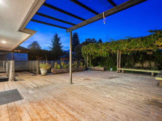 Enjoy outdoor living on this spacious wooden deck, perfect for entertaining or relaxing.