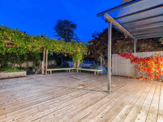 Step onto this expansive wooden deck, perfect for outdoor entertaining and relaxation.