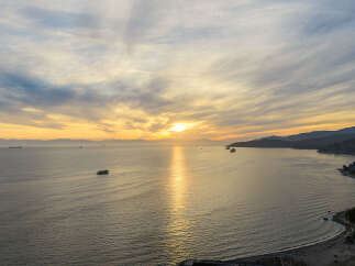Experience breathtaking sunsets from this stunning waterfront property, offering panoramic ocean views and direct beach access.