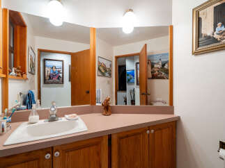 This charming bathroom features a spacious vanity with a double sink and ample storage below.