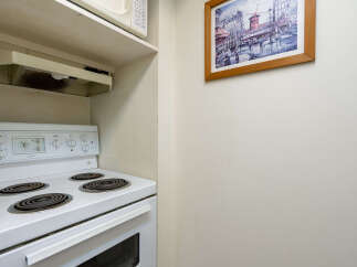 This cozy kitchen features a white electric stove with four burners and a built-in oven, perfect for preparing meals.