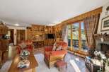 Experience cozy living in this charming mountain retreat, featuring rustic wood paneling and a warm, inviting atmosphere.