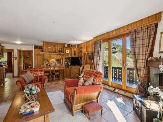 Experience cozy living in this charming mountain retreat, featuring rustic wood paneling and a warm, inviting atmosphere.