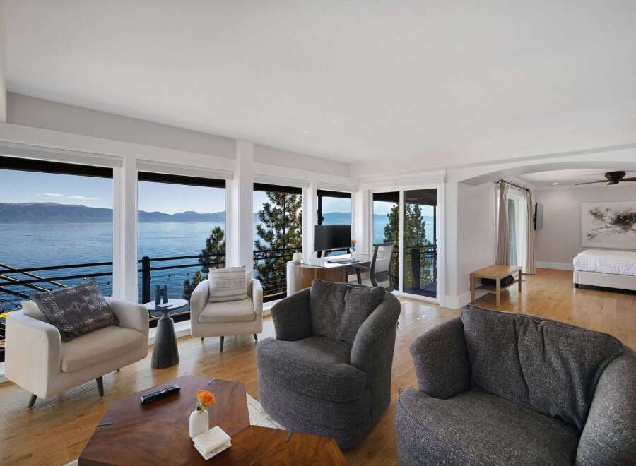 Experience breathtaking lake and mountain views from this stunning living space, featuring expansive windows that flood the room with natural light.