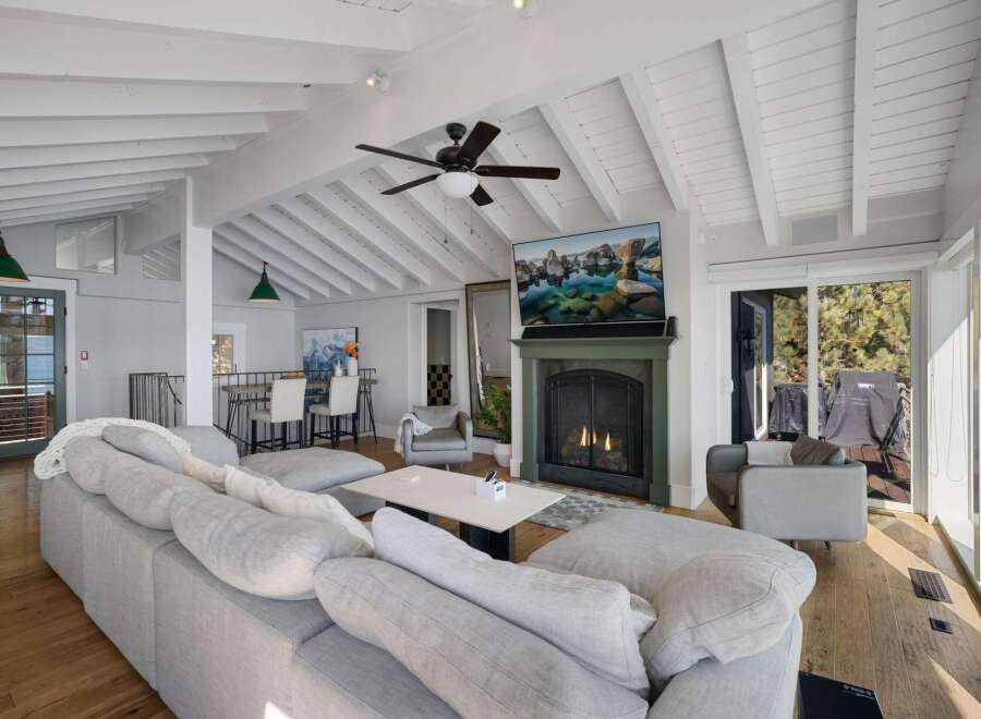 Experience coastal living in this stunning living room, featuring a cozy fireplace and a large sectional sofa perfect for relaxation.