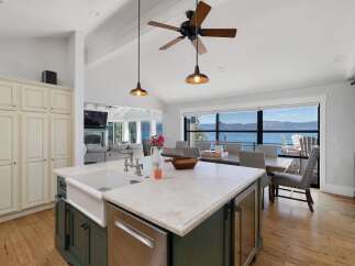 Experience breathtaking lake and mountain views from this stunning open-concept living space.