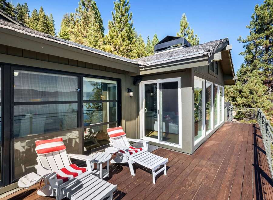 Enjoy breathtaking lake views from this expansive wooden deck, perfect for outdoor entertaining or quiet relaxation.