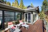 Enjoy breathtaking lake views from this expansive wooden deck, perfect for outdoor entertaining or quiet relaxation.