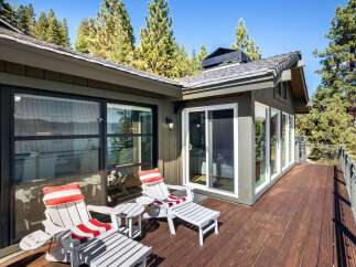 Enjoy breathtaking lake views from this expansive wooden deck, perfect for outdoor entertaining or quiet relaxation.