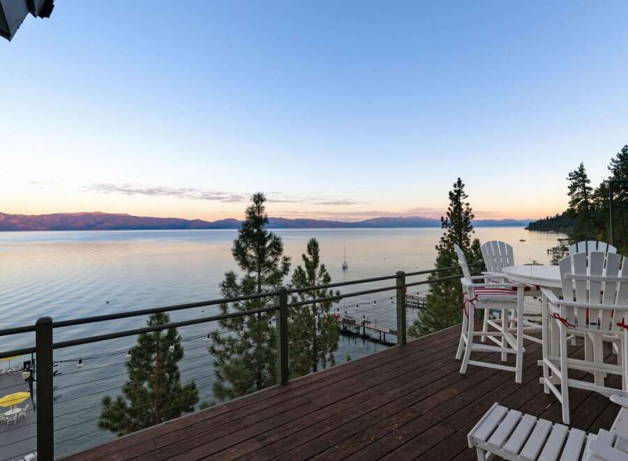 Enjoy breathtaking lake views from this stunning property's expansive deck, perfect for entertaining or quiet relaxation.