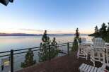 Enjoy breathtaking lake views from this stunning property's expansive deck, perfect for entertaining or quiet relaxation.