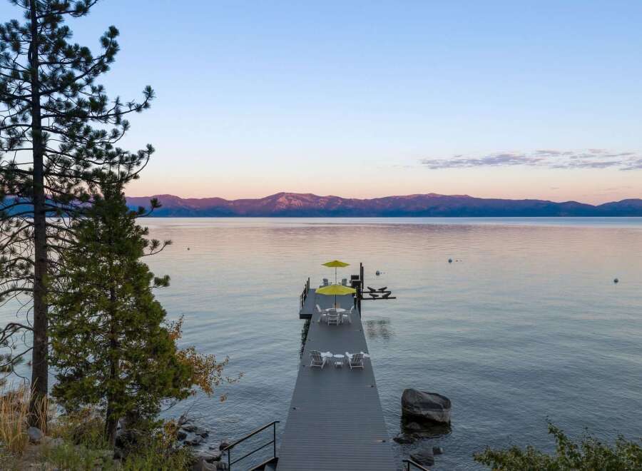 Experience serene lakefront living with this stunning property featuring a private dock perfect for morning coffee or evening relaxation.