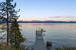 Experience serene lakefront living with this stunning property featuring a private dock perfect for morning coffee or evening relaxation.