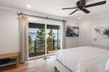 Wake up to breathtaking lake and mountain views from this stunning bedroom.