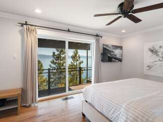 Wake up to breathtaking lake and mountain views from this stunning bedroom.