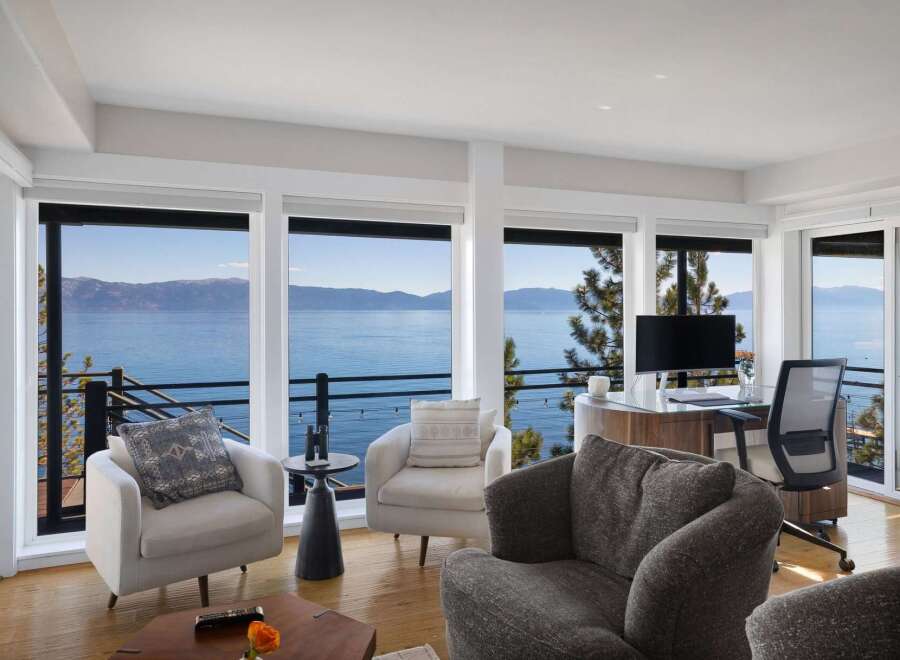 Experience breathtaking lake and mountain views from this stunning living space, featuring expansive windows that flood the room with natural light.