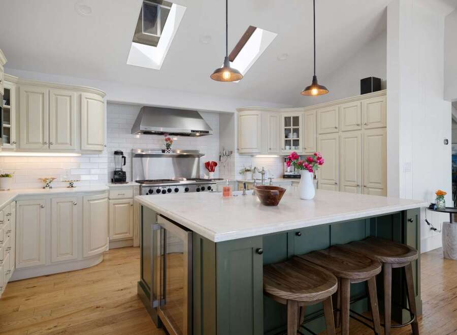 This spacious kitchen boasts a large central island with seating, perfect for casual dining and entertaining.