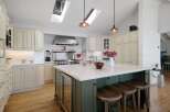 This spacious kitchen boasts a large central island with seating, perfect for casual dining and entertaining.