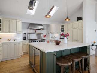 This spacious kitchen boasts a large central island with seating, perfect for casual dining and entertaining.