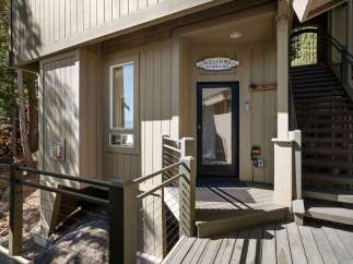 Welcome to your lakeside retreat! This charming property features a welcoming entrance with a 'Welcome to the Lake' sign, perfect for setting the mood.