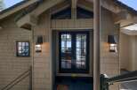 Welcome guests to your home with this charming entryway featuring a set of dark-framed double doors that open to a stunning view of the water.