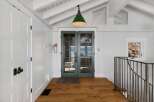 Step into this charming entryway featuring a bright and airy atmosphere, complemented by a vaulted ceiling and exposed beams.