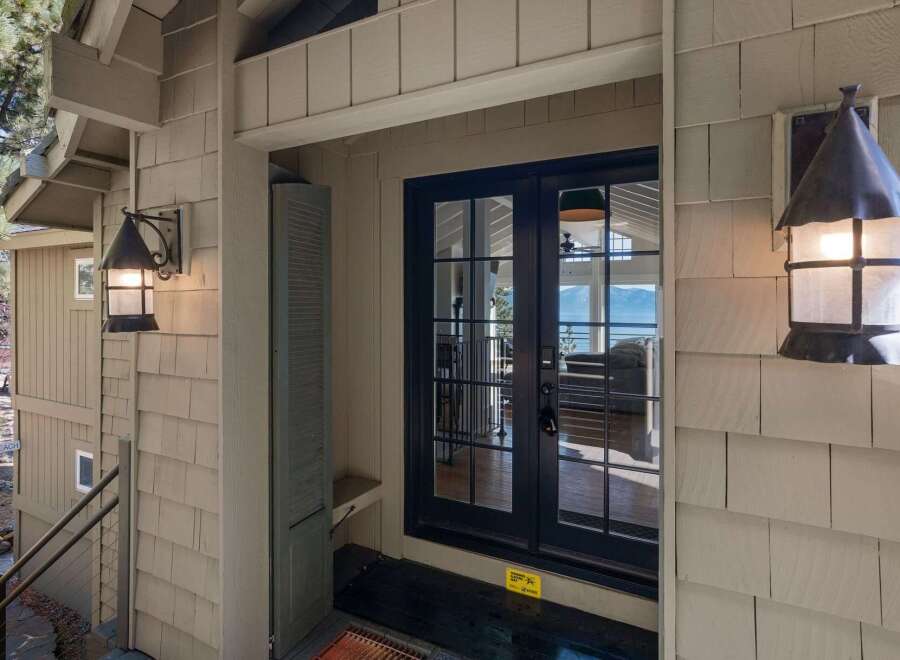 Welcome guests to your home with this charming entryway featuring rustic outdoor lighting and a covered porch.