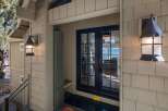 Welcome guests to your home with this charming entryway featuring rustic outdoor lighting and a covered porch.