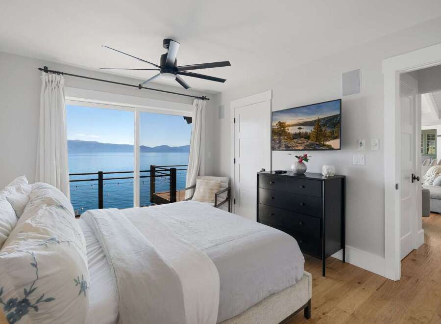 Wake up to breathtaking lake views from this stunning bedroom.