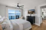 Wake up to breathtaking lake views from this stunning bedroom.