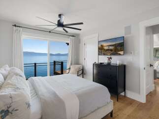 Wake up to breathtaking lake views from this stunning bedroom.